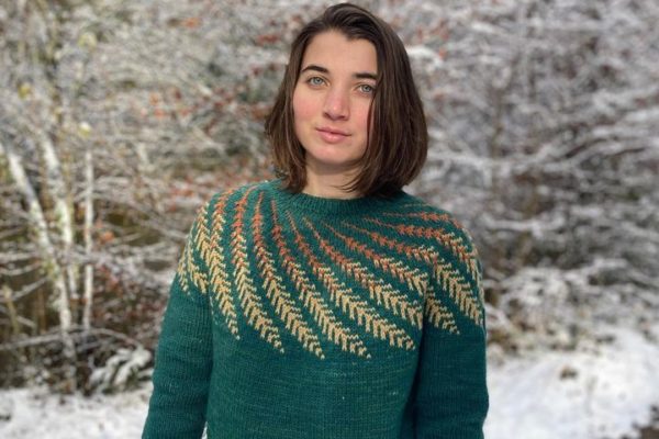 Green knitted sweater with a complex leave pattern