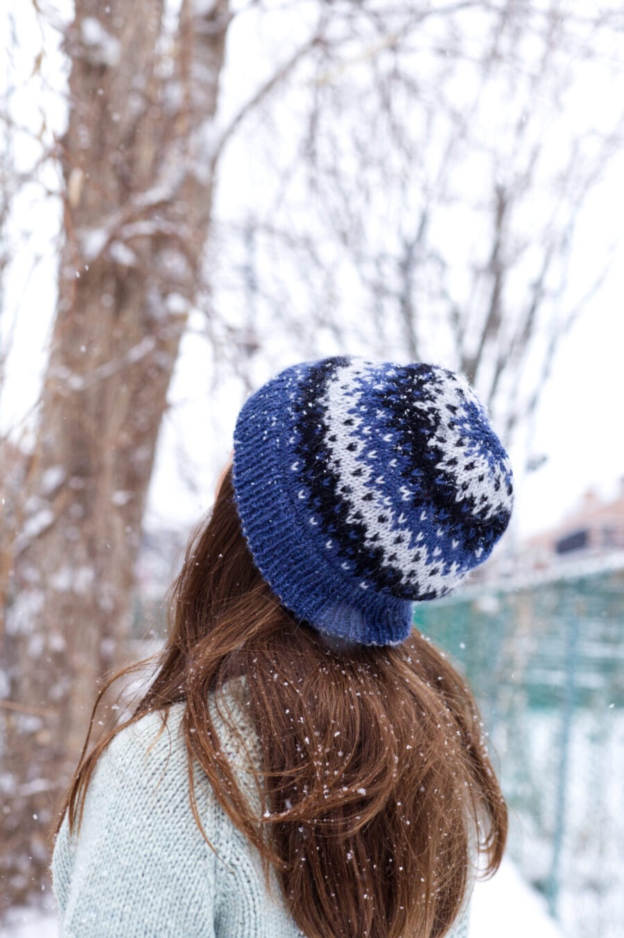 3/4 view of the Matau hat, knit in a three-colour colourwork pattern. Tuque, beanie.