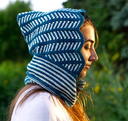 Closeup side view of Lollyzag, a knitted Balaclava/Hood with chevron stripes and a cowl