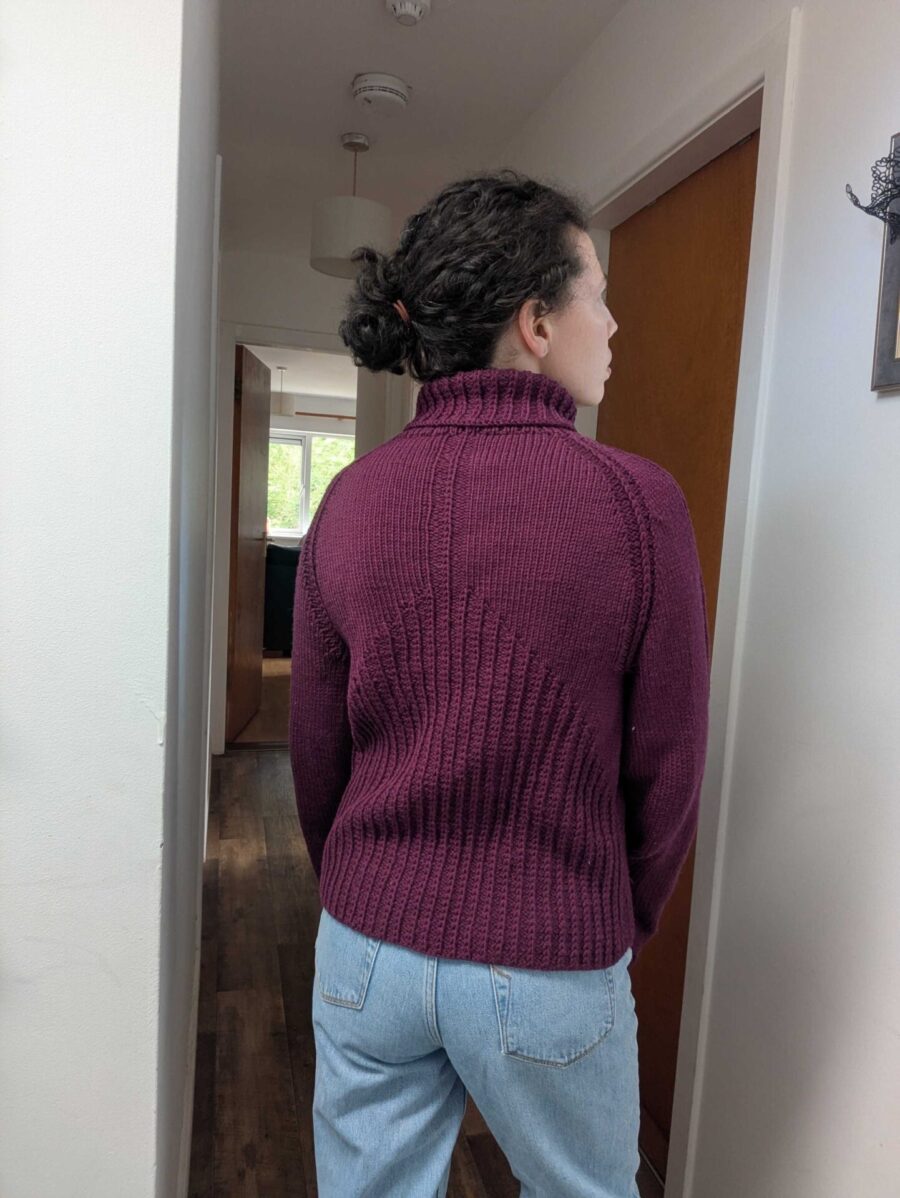 Back view of Aisling wearing a custom-fit purple kerleva sweater