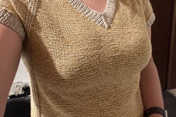 Katharina is wearing a custom fitted Strawberry Strudel sweater in beige and white wool.