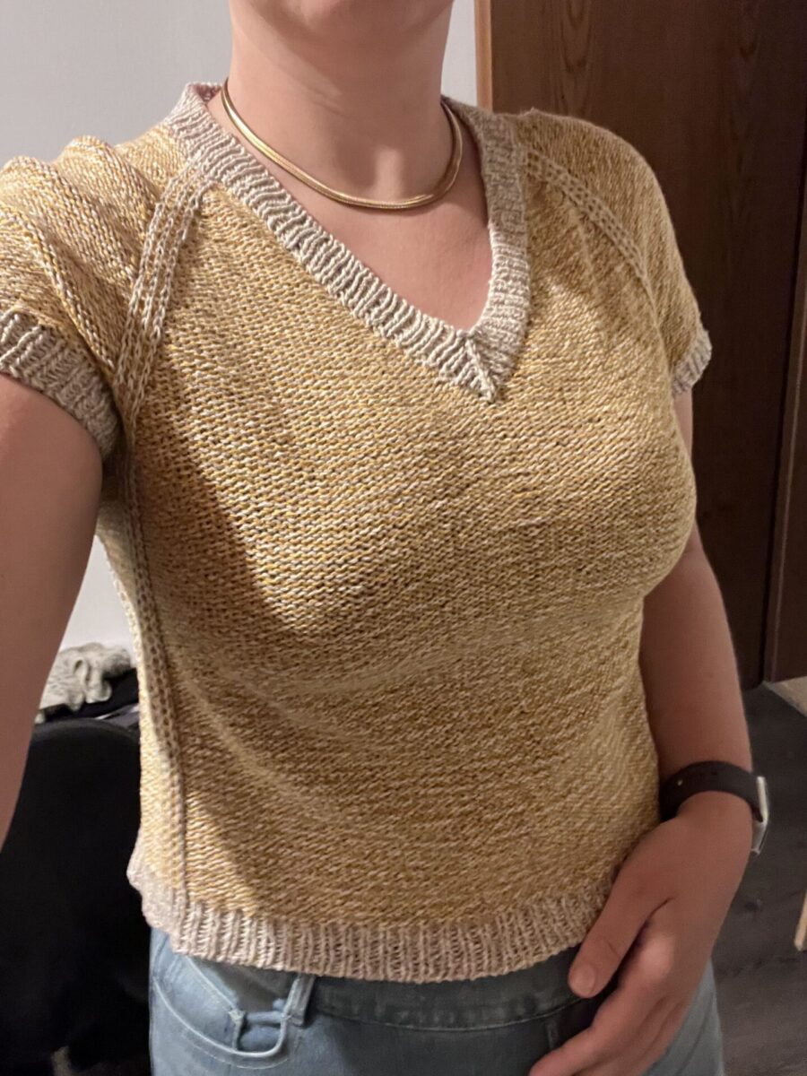 Katharina is wearing a custom fitted Strawberry Strudel sweater in beige and white wool.