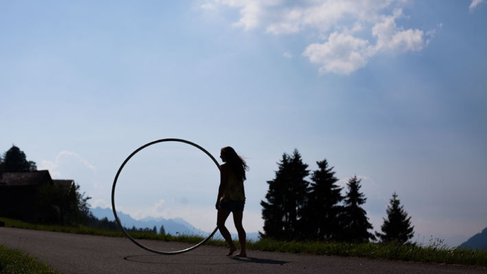 Cyr wheel silhouette capturing mountains