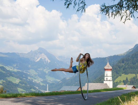 Floating in cyr wheel on a mountain road