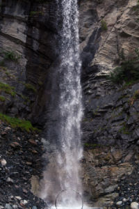 Cyr wheel under a tall waterfall