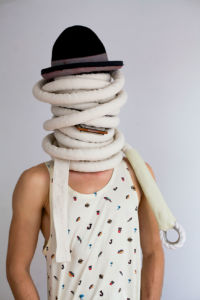 Corde lisse wrapped around head playing the harmonica