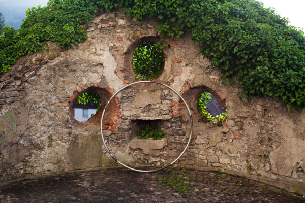 Cyr Wheel and holes in an old wall