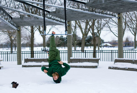 Hanging from trapeze on one foot watching a boot