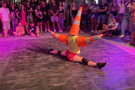 Acrobat with cones making a split