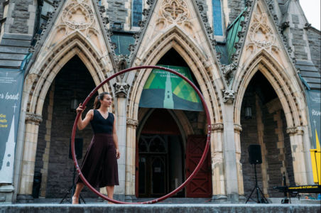 Standing with Cyr wheel in front of cathedral