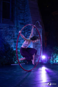 Spinning in a Cyr wheel at night in blue light